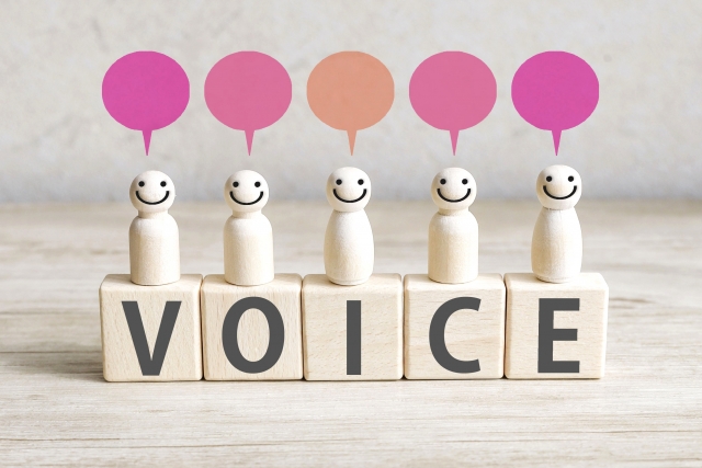 VOICEと書かれたブロックと木製の人形